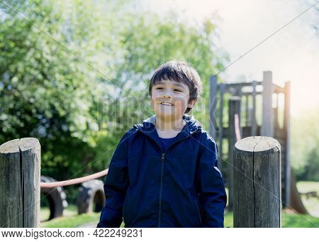 Portrait Happy Boy With Smiling Face Playing In The Park, Active Kid Having Fun In The Playground On