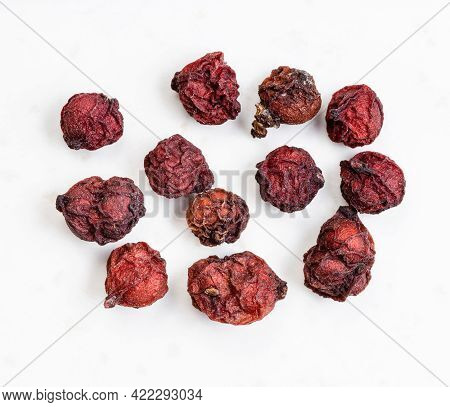 Few Dried Magnolia Berries (schisandra Chinensis Fruits) Close Up On Gray Ceramic Plate