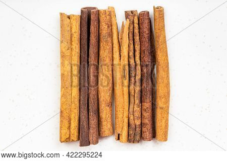 Top View Of Several Sticks Of Cassia Cinnamon Close Up On Gray Ceramic Plate
