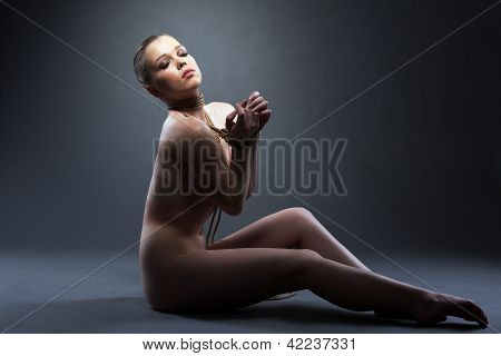Slim young woman posing naked with shibari
