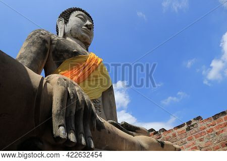 Big Buddha Image With A Blue Sky During The Day.