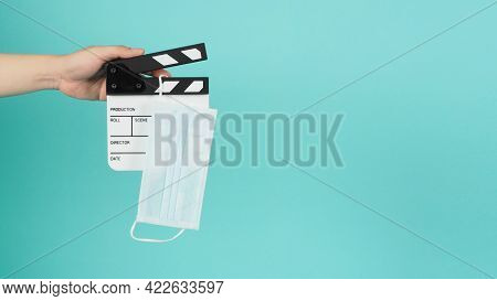 Fack Mask On Clapperboard And Hand Is Holding Clapper Board Or Movie Slate.it Is Used In Film Produc