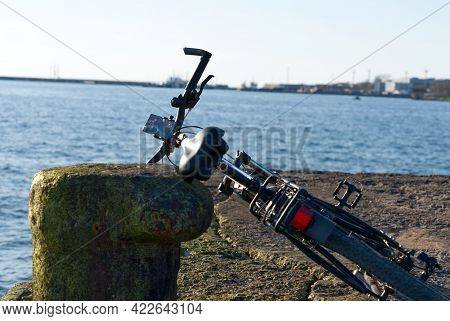 Bike On The Wharf Overlooking The Sea. Baltic Sea. Sunset
