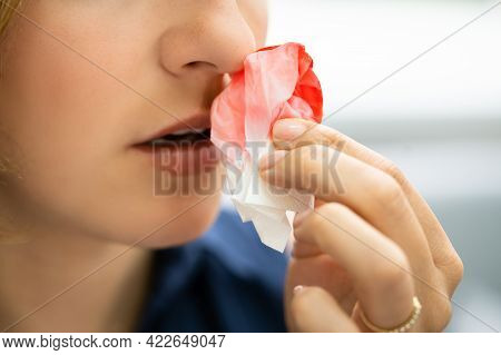 Woman Trying To Stop Blood Bleeding From Nose