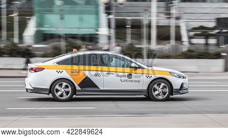 Moscow , Russia - April 2021: White Yandex Taxi On The Moscow Streets In Motion. Business Class Hyun