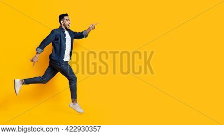 Excited Middle-eastern Man Running Towards Copy Space