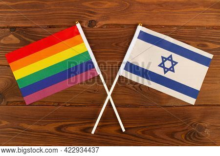 Rainbow Flag Lgbt And Flag Of Israel On Brown Wood Planks Background. Lgbt Pride Month. Lgbtq. Lgbtq