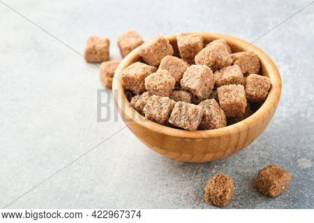 Cane Sugar Cube In Bamboo Bowl On Gray Table Concrete Background. Top View.