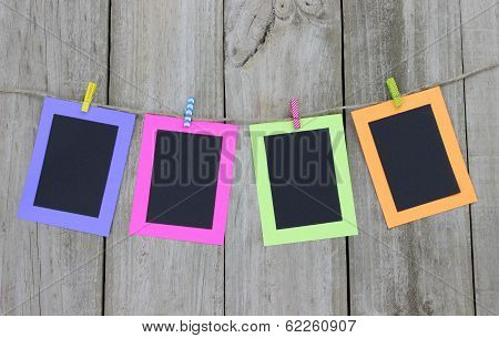 Colorful frames hanging on clothesline