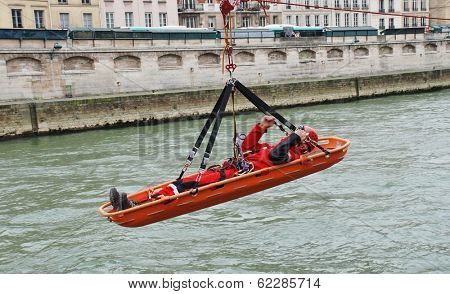 PARIS, FRANCE - MARCH 18, 2014: Firefighters of the elite GRIMP unit carry out a training exercise at the Pont Saint Michel on the River Seine. The unit specialises in rescues in hazardous situations.