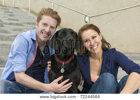 Happy Couple Having Fun With Dog