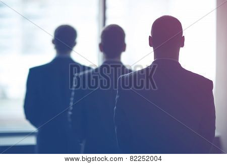 silhouette of three businessmen in the office