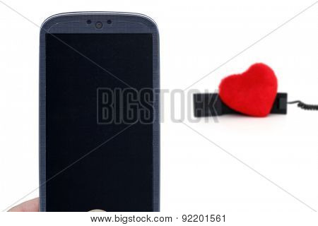 Blue smartphone and blurred telehone with heart. Idea for Valentines Day calls, love, lovers, love apps, Internet, blogs and others.
