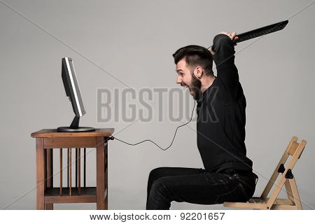 Angry man is destroying a keyboard