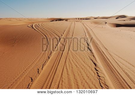 Tyre / Tire Tracks Through The Desert Sand Dunes and Fork in Path