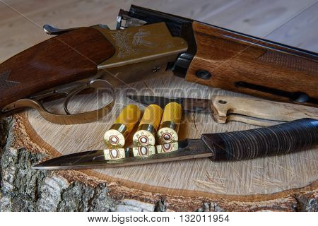 hunting rifle and ammunition, cartridges, on a wooden table.