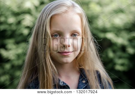 Portrait of a beautiful blonde little girl with long hair