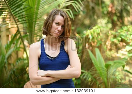 An upset young women with arms crossed and sad or powerless expression