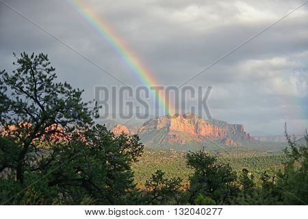 Stormy clouds over Sedona Arizona with bright rainbow