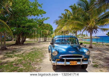 VARADERO, CUBA - MAY, 22, 2013: Blue american classic car on the beach