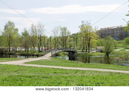 PETROZAVODSK, RUSSIA - MAY 10TH, 2016: Springtime cityscape, river and bridges in the city park in northern Russia, Petrozavodsk