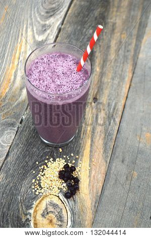Blueberry and steel cut oats smoothie on a wood background