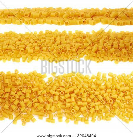 Line made of dry ditalini yellow pasta over isolated white background