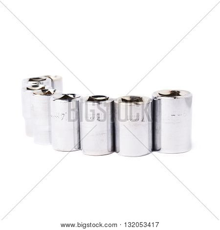 Line of metal hex socket of spanner over isolated white background