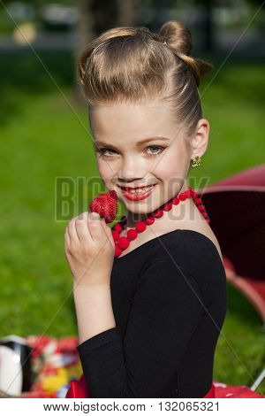 Pin-Up. Lovely little girl in the retro red dress in summer park