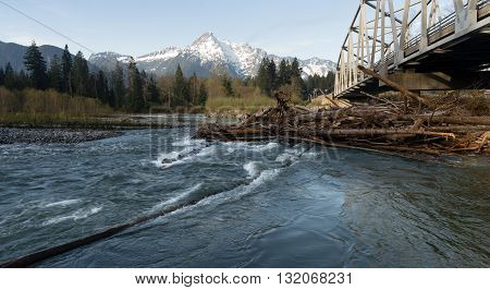 Logs jam up under the bridge on the Sauk