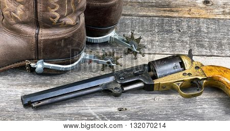 Old western pistol, spurs and cowboy boots.