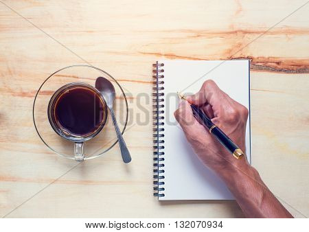 Drink coffee and write notebook on office dask