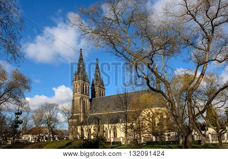 Medieval church cloudless day in Prague, view from the park