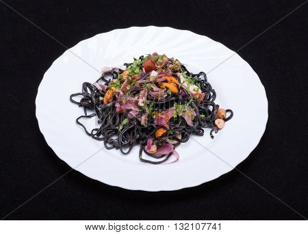 Black Spaghetti With Seafood And Vegetables On White Plate