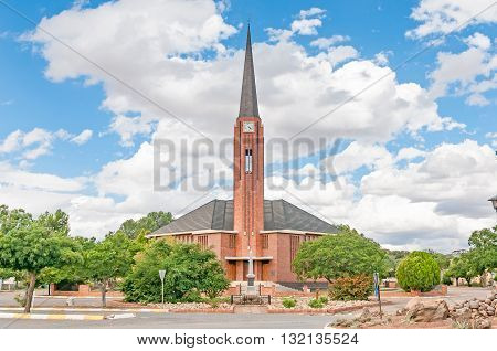EDENBURG SOUTH AFRICA - MARCH 8 2016: The Dutch Reformed Church in Edenburg a small town in the Free State. A monument for local citizens who died in the Anglo-Boer war 1899-1902 is in front