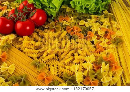 Various types of Italian pasta and cherry tomato. Spaghetti. Pasta. Italian food. Noodles.