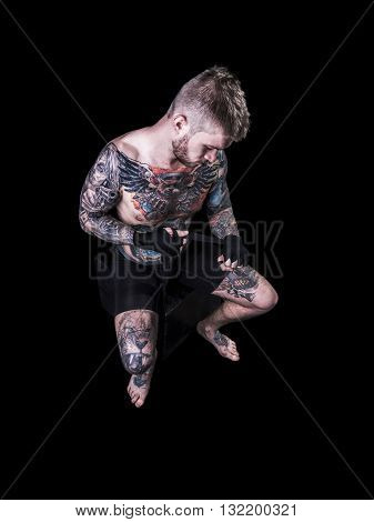 MMA Fighter Preparing Bandages For Training on black background