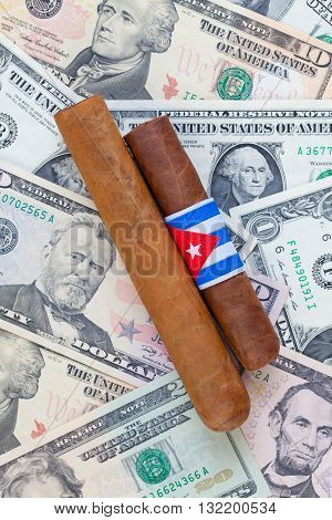 Detail of luxury Cuban cigars on the US dollar banknotes