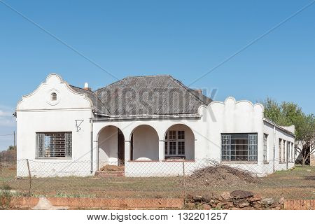 An empty house in Springfontein in the Southern Free State with several broken windows typical of the decline of rural areas
