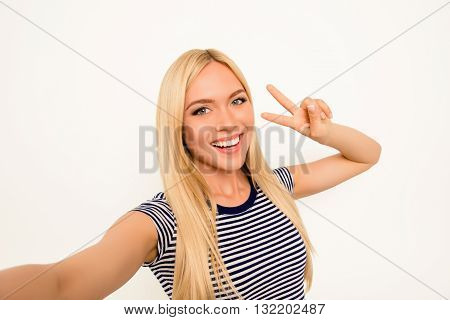Blonde Happy Woman Making Selfie And Showing Two Fingers