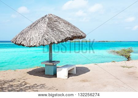 Grass umbrella at the beach on Aruba island