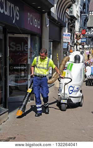 CHESTER, UK - JULY 22, 2014 - Street cleaner along Eastgate Street Chester Cheshire England UK Western Europe, July 22, 2014.