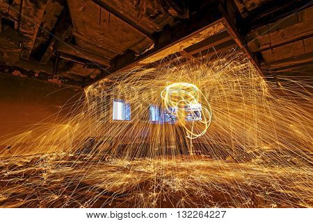 Burning Steel Wool spinning. Showers of glowing sparks from spinning steel wool in ruins