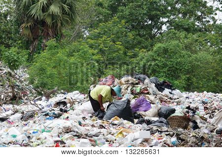 Penh Thailand - May 31 2016: Poor people searching on disposal site for useful things to recycle or resell in Northeast of Thailand.
