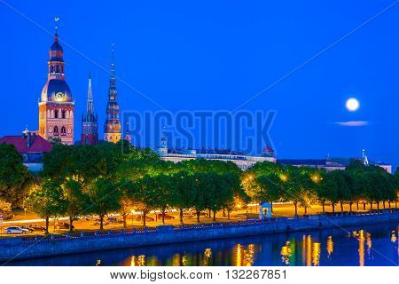 Old Town Of Riga With Reflection In Daugava River At Night. Riga, Latvia