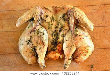 Cooked spatchcock (butterfly) chicken with herb crust