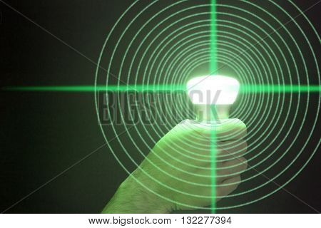Hand holds a glowing green bulb emitting circular data Lifi concept