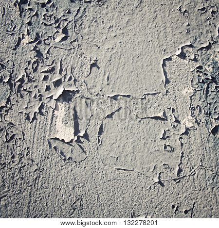Old wall close up with copy space area. Aged photo. Cracked white paint on concrete surface. Frame with copy space area. Vintage filter photo.