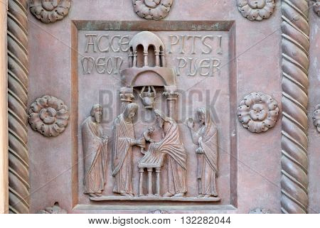 PISA, ITALY - JUNE 06, 2015: Presentation of Jesus in the Temple on the San Ranieri gate of the Cathedral St. Mary of the Assumption in Pisa, Italy on June 06, 2015
