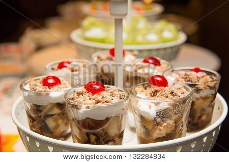 Banoffee pie in a mini glass spilled with caremel and whipped cream delicious dessert.